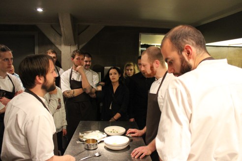 Presenting his dish to the staff.